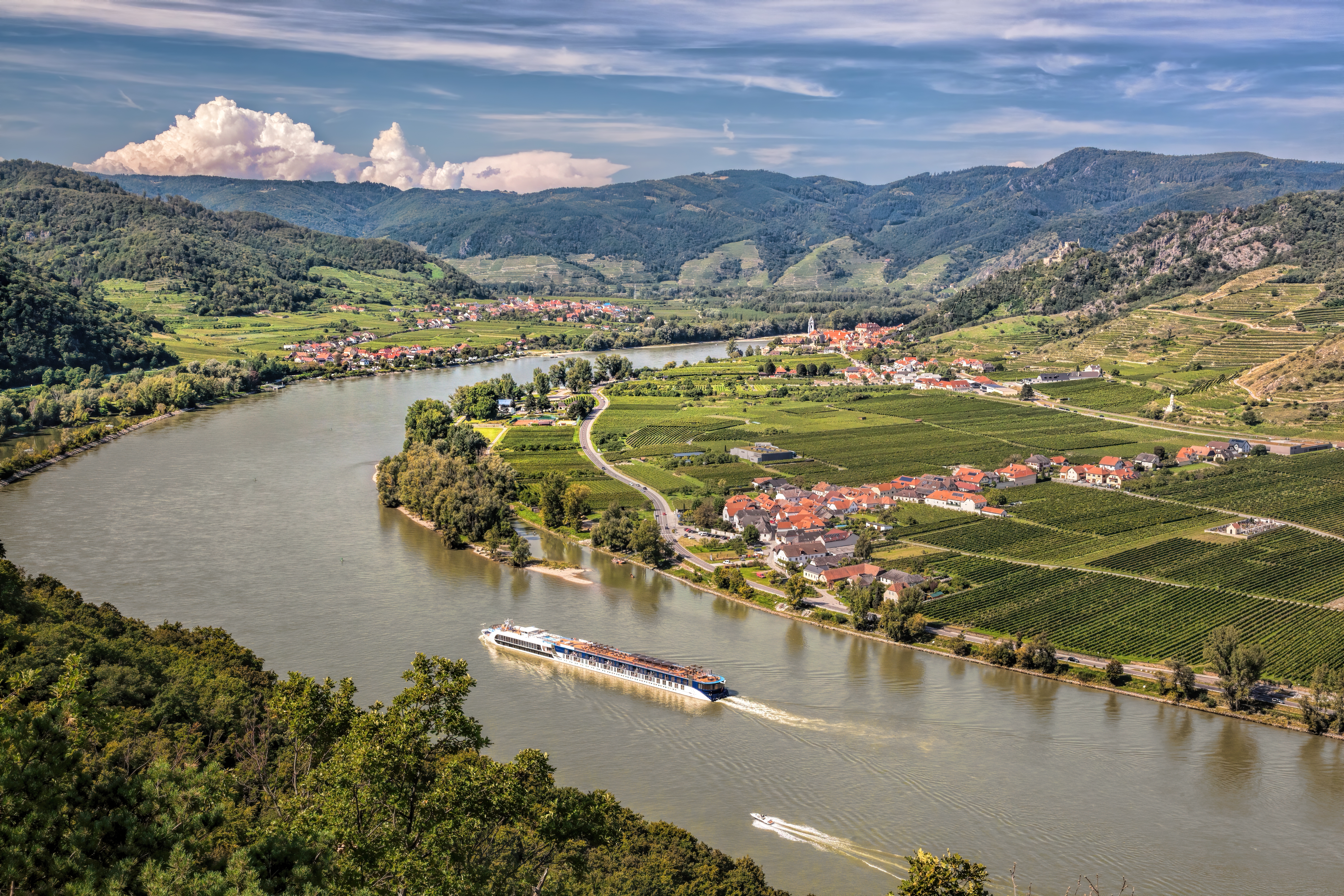 Panorama of Wachau valley (Unesco world heritage site) with ship on Danube river against Duernstein village in Lower Austria.
